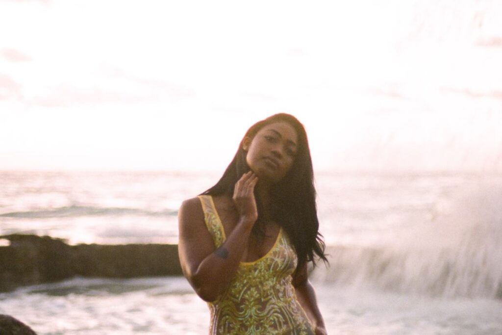 A woman standing in the surf at golden hour